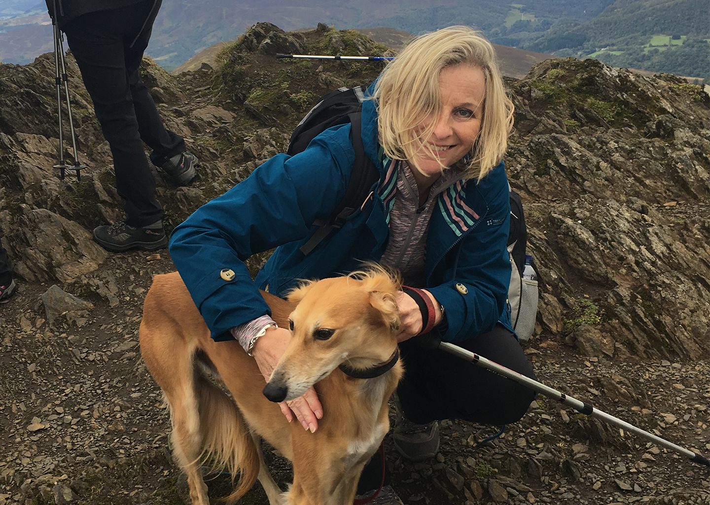 Faye Gibb with a dog on top of a mountain. Account Manager at TurnbullRipley creative agency.